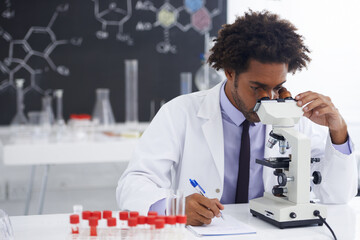 Hmm, this is an interesting development.... Shot of a male biologist looking at a glass slide...