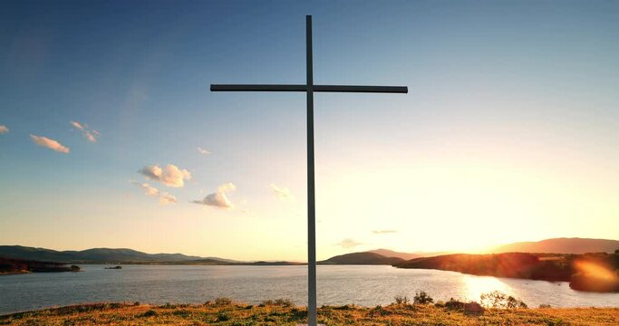 Sunrise over ocean and beach shore and holy cross on the sea cliff