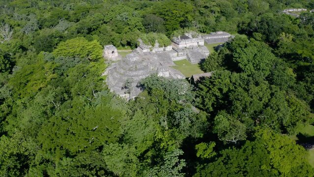 Aerial view around a temple in Ek Balam, sunny, Yucatan, Mexico - orbit, drone shot
