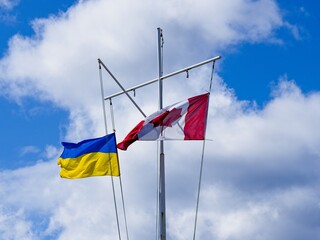 Ukrainian and Canadian flags raised on the mast in sign of support of Ukraine