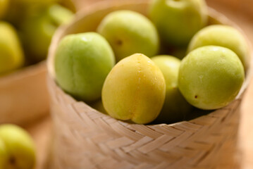 Apricot green with yellow (Japanese apricot) in bamboo basket, Close up