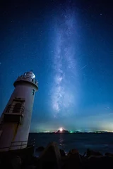 Keuken spatwand met foto The lighthouse emitted shining rays both in the sky and at sea. © Yuji Shiraishi
