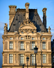 Fototapeta na wymiar The facade of the Louvre Museum building (Paris, France). Typical architecture of a Parisian Haussmannian building 
