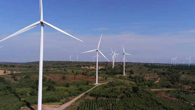 Aerial view of wind turbine . Sustainable development, environment friendly, renewable energy concept.Windmill in the morning on blue Sky. wind turbine in feilds.