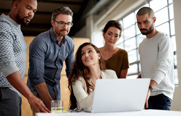 Getting their opinion on her project. Shot of a group of businesspeople meeting in the boardroom.