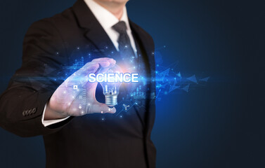 Businessman holding a light bulb