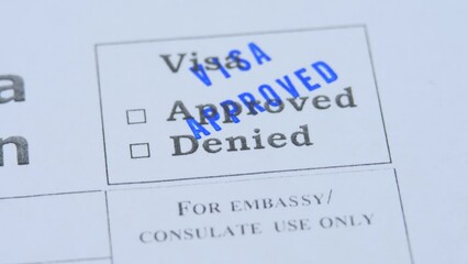 Stamping approved visa decision. Paper application form to travel or immigration. Embassy officer check document. Permission for foreigner country. Success interview. Emigration and immigration