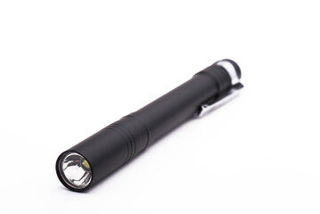 Black compact metal flashlight isolated on white background