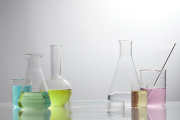 Front view of laboratory equipment filled with colorful fluid in a beaker test tube in lab background for experiment advertising 