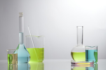 Front view of laboratory equipment filled with colorful fluid in a beaker test tube in lab...