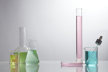 Front view of laboratory equipment filled with colorful fluid in a beaker test tube in lab...