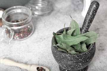 Dried bay leaf, laurel in a mortar. Food ingredient.Spices and condiments for cooking and alternative therapy