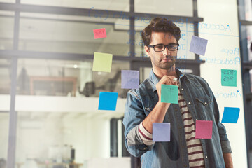 Bringing it all together. Shot of a young designer playing around with ideas.
