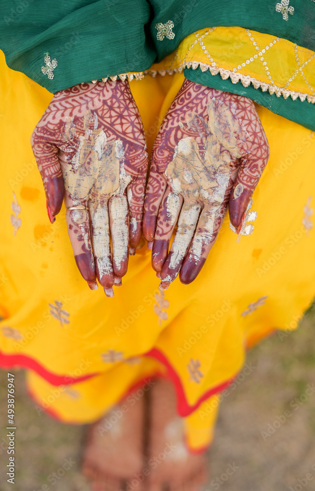 Wall mural Traditional Haldi turmeric kept on a flower plate for the hindu marriage ceremony. This paste of sandal, oil and turmeric is applied by all relatives before the wedding to make the bride or groom.