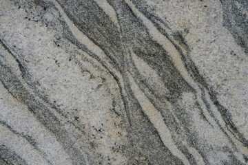 Stonewall background, the abstract texture of gray gneiss rock.	