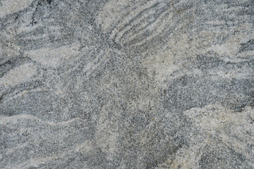Gray marble stone wall background. the abstract texture of gneiss rock.