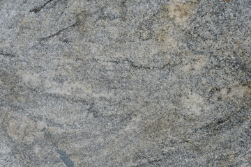 Gray marble stone wall background. the abstract texture of gneiss rock.