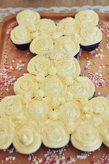 Cupcakes makes any party fun. High angle shot of yummy cupcakes on a table at a tea party inside.