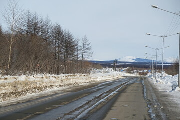 An old country road with snow along it.