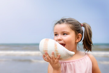 Happy child with seashell