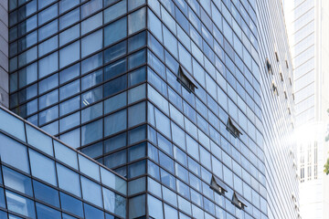 Fototapeta na wymiar The exterior glass curtain wall of modern urban office building