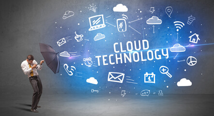 Businessman defending with umbrella, modern technology concept