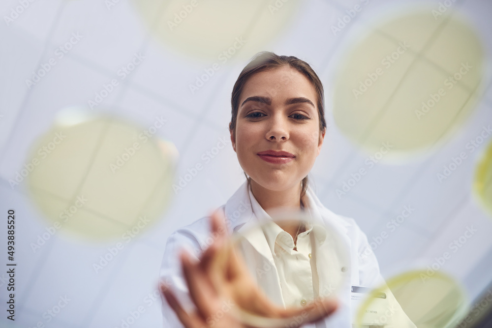 Poster Uncovering the next major breakthroughs in science. Low angle shot of a young scientist conducting an experiment in a lab.