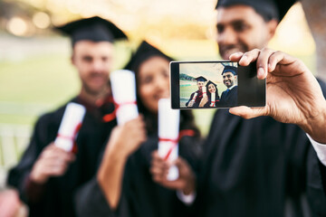 Its their proudest moment. Shot of a group of students taking a selfie together on graduation day.