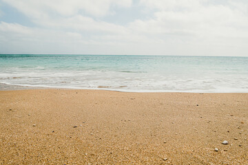 Deserted beach waves and sky