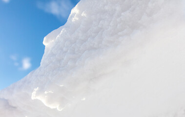 Fototapeta na wymiar White snow against the blue sky.