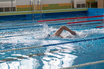 A man swims in a sports pool.