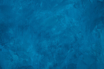Fototapeta na wymiar Blue colored abstract textured background. Decorative plaster on the wall