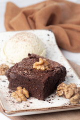 chocolate and walnut brownie with vanilla ice cream. selective focus. copy space. close up shot