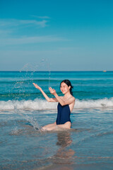 Cheerful woman having fun in the ocean
