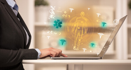 Doctor working on laptop with healthcare concept