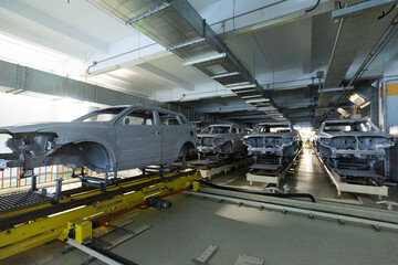 Obraz premium Car bodies are on assembly line. Modern automotive industry. Automobile conveyor
