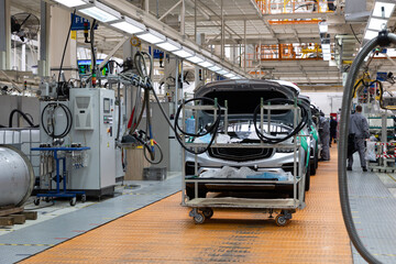 Car bodies are on assembly line. Factory for production of cars. Modern automotive industry. Electric car factory, conveyor