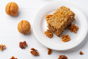 Piece of nut cake on white plate