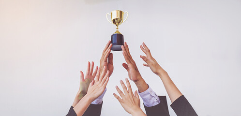 Hands scramble for the golden trophy cup, concept business - obrazy, fototapety, plakaty