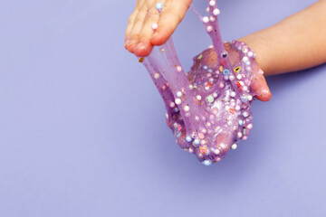 Making slime at home. child stretching colorful slime. DIY concept.