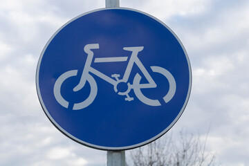 Close up shot of traffic sign for cyclists with cloudy sky background