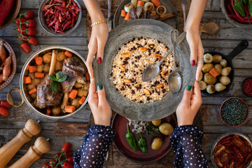 A cooked rice pilau with two spoons