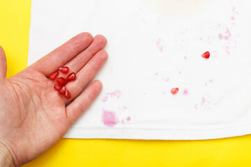 Obraz na płótnie Canvas dirty stains on white baby clothes from a pomegranate