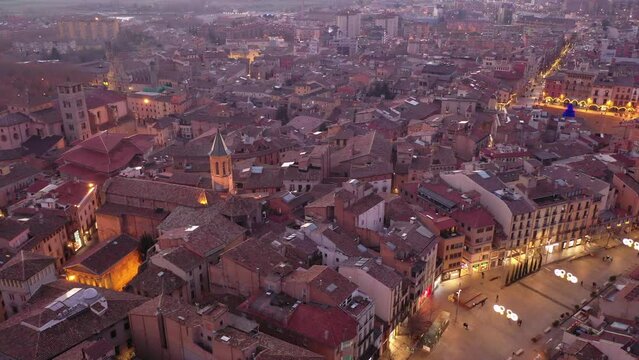 Aerial view of historic district of Vic town with ancient cathedral on winter twilight, Catalonia, Spain. High quality 4k footage