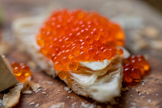 Bread with caviar in "Russian style" on wooden background.