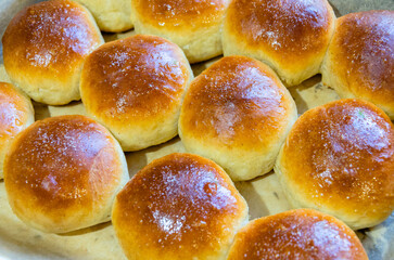 Fresh buns on a baking sheet. View from above.