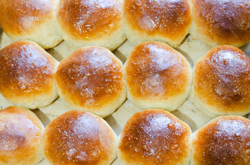 Fresh buns on a baking sheet. View from above.