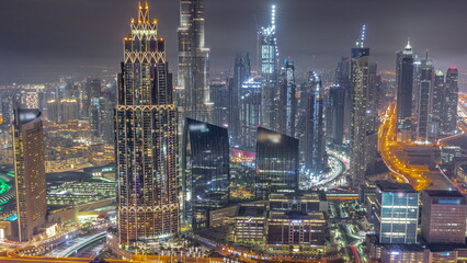 Fototapeta na wymiar Aerial view of tallest towers in Dubai Downtown skyline and highway all night timelapse.