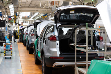 Car bodies are on assembly line. Factory for production of cars. Modern automotive industry. Electric car factory, conveyor