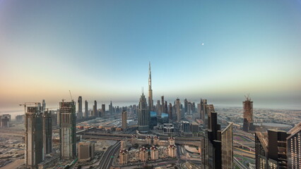 Fototapeta na wymiar Aerial view of tallest towers in Dubai Downtown skyline and highway timelapse.